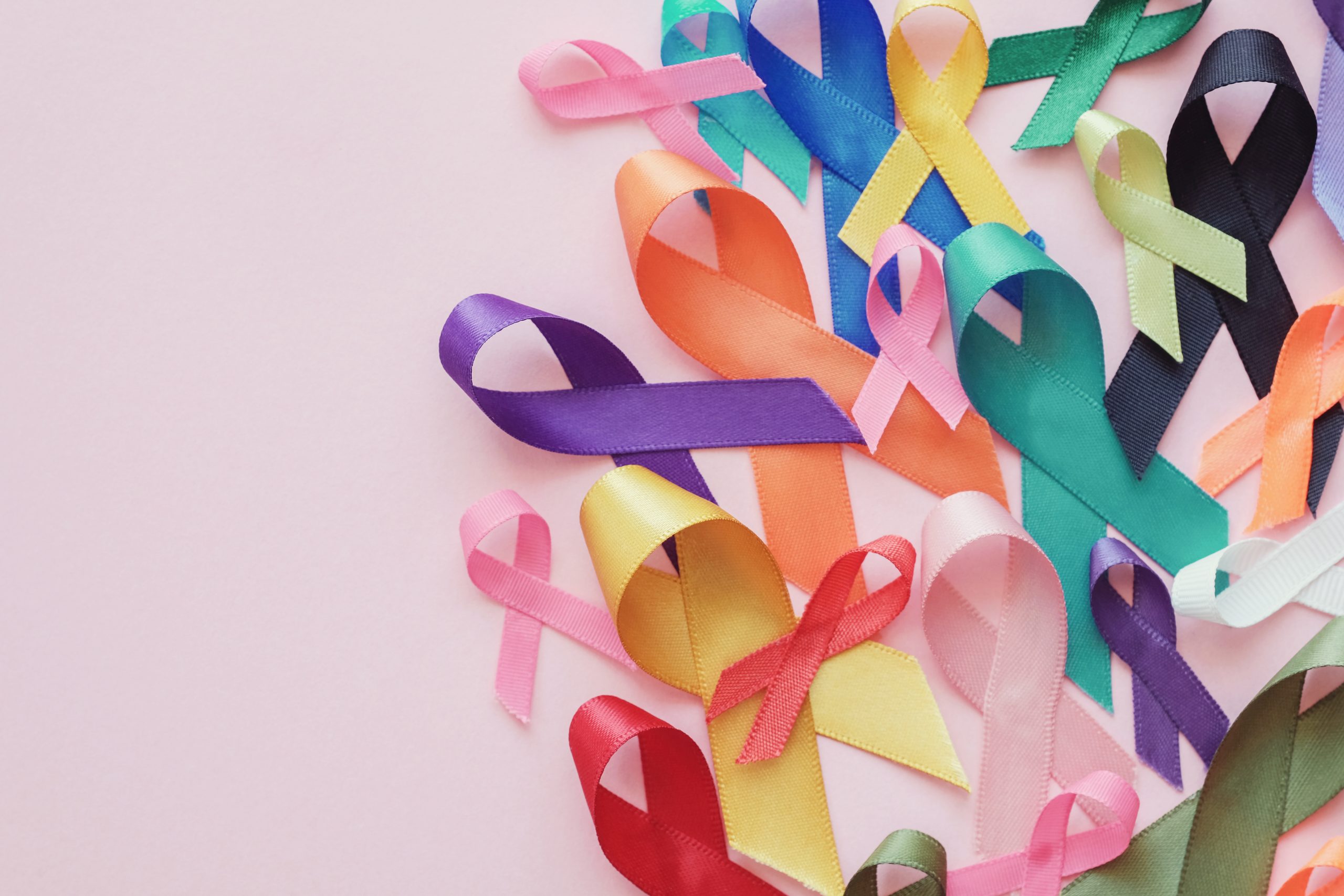colorful ribbons on pink background, cancer awareness, World cancer awareness